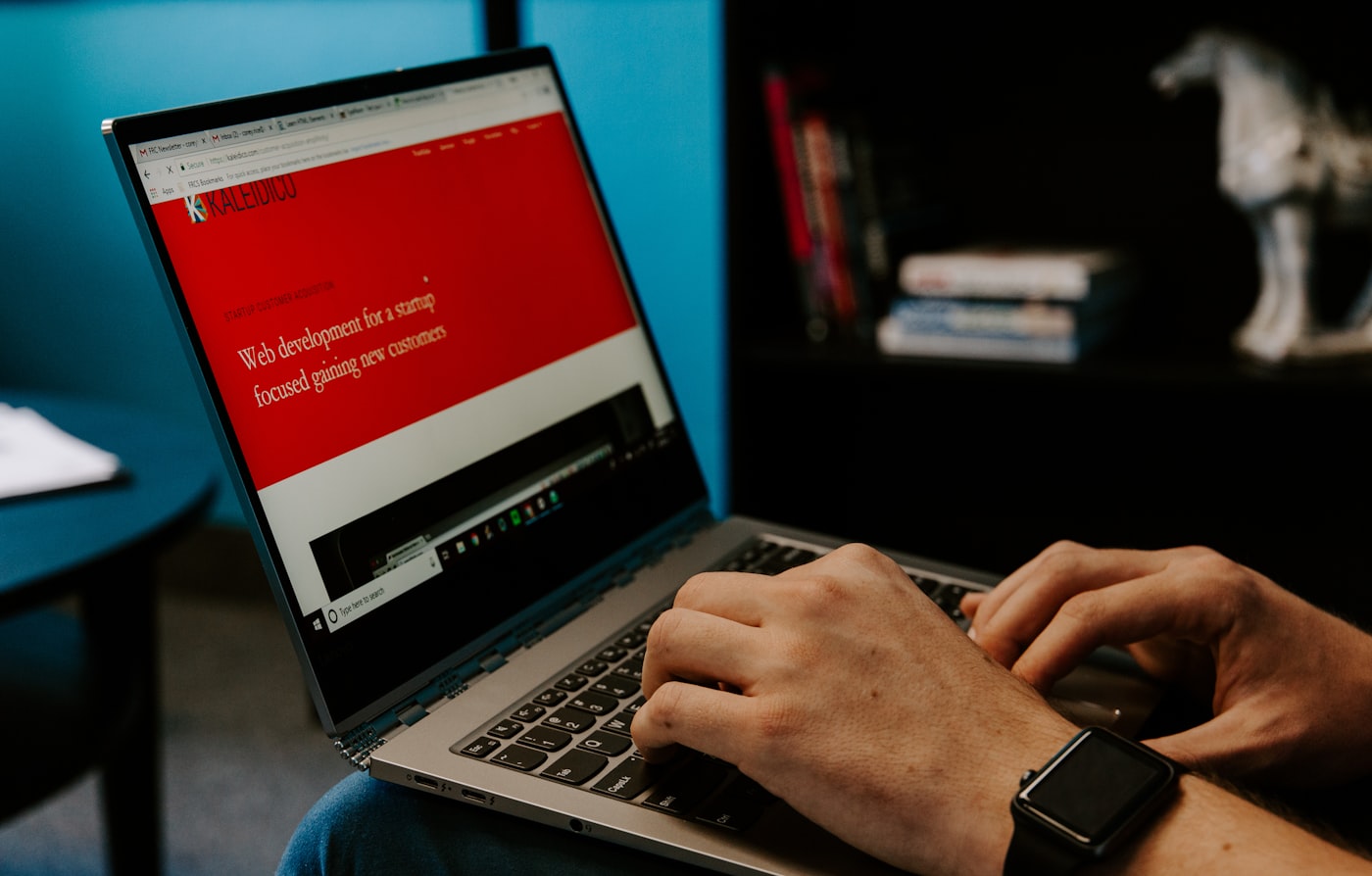 Business professional using a laptop for web and support work
